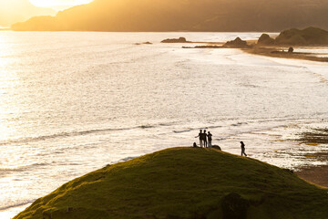 Indonesian teens creating social media content at sunset, Lombok, Indonesia