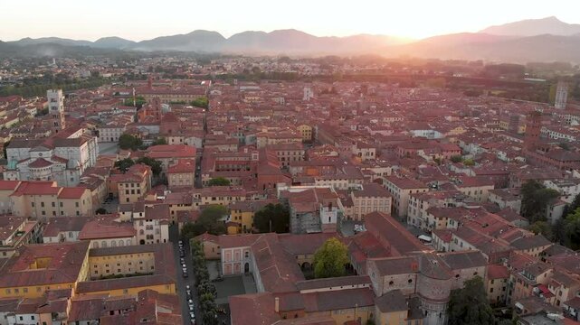 Aerial sunset evening view of famous Lucca city, known for its intact Renaissance-era city walls and well preserved historic center. Province of Lucca, Tuscany, Italy.