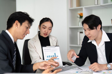 Data Presentation and Collaboration. Team members engaging in a business discussion with charts and digital tools.