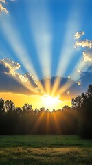 Sunset rays through clouds over field