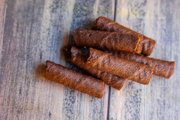 a bunch of delicious chocolate astor isolated on wooden board background