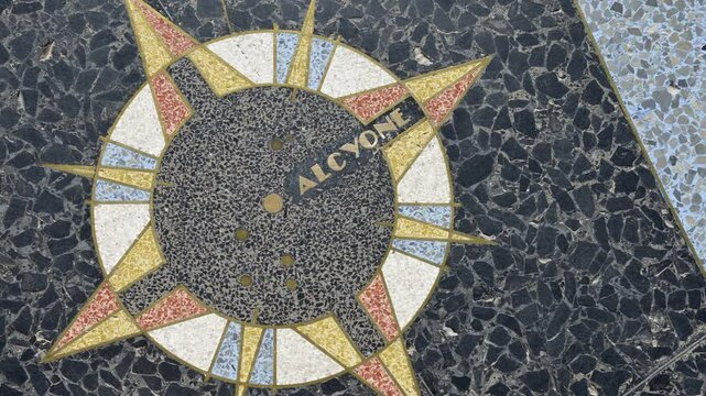 The intricate Alcyone inlay is featured prominently in the star chart celestial map created by Oskar J.W. Hansen, located at Hoover Dam in Arizona-Nevada. Visitors admire its design.