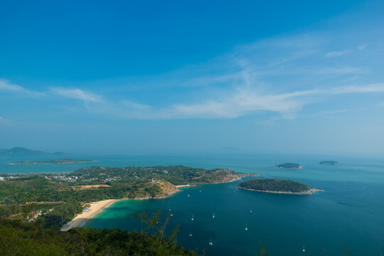 Aerial view of tropical island in the blue ocean sea and boats, in phuket
