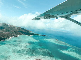 Passenger view of a private plane flying over Australia's Great Barrier Reef © Suzie