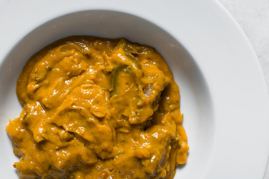 Overhead view of Nigerian owo soup with fish and beef, traditional owo soup in a bowl