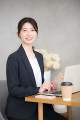 Vertical of a young woman typing on a laptop, changing jobs, hiring, and HR image camera eye view.	