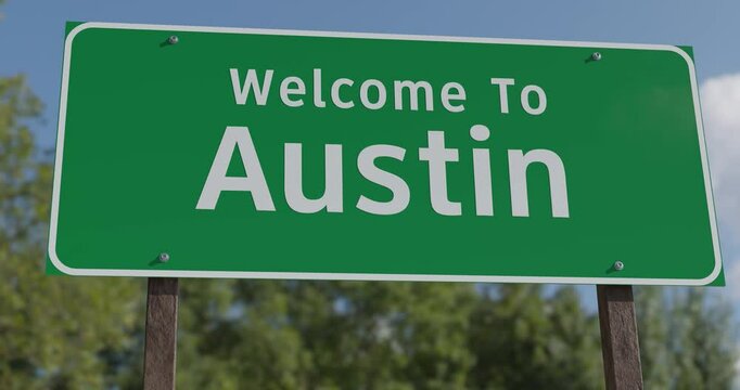 Driving By A Welcome To Austin, Texas Green Road Sign Against a Blue Sky and Clouds - United States Capital Series.