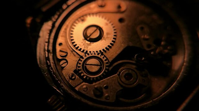 Close up of inner mechanism of a vintage watch with changing lighting
