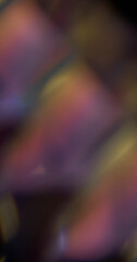 Illuminated leak. Blur flare texture. Defocused pink purple yellow multicolor rainbow light on abstract art dark black background.