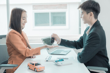 The customer checks the car loan agreement. insurance contract and other business documents required for purchasing vehicles, loans, businesses, electric cars.