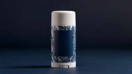 Elegant, patterned deodorant stick on a dark blue background, combining hygiene with an eye-catching design for daily freshness.