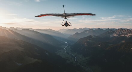 Hang gliding over mountainous valley at sunrise adventure sport concept