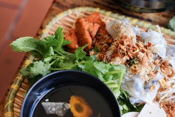 Hanoi-style banh cuon, rice noodle rolls with ground pork, served with cha lua (sausage), fresh...