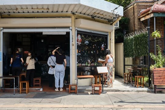 Marrickville, NSW - Dec 28, 2023: Customers queuing up to order food at VN Street Foods, a restaurant serving North Vietnamese street food such as pho tai lan, Hanoi bun cha and banh cuon in Sydney