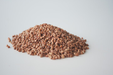 Freshly harvested seeds arranged in a neat pile on a white surface
