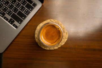 Espresso shot in a glass on a desk