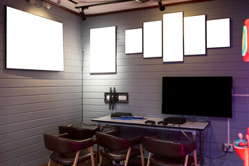 Game controller in front of TV. Simple living room interior design with sofa, console, mockup poster frame.