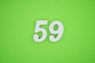 The numbers are made of white painted wood placed on a green paper background.