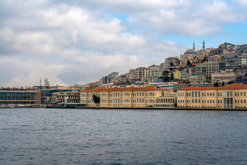 View of the embankment-boulevard of the Galataport shopping and entertainment center in the Karakey area and the Cihangir Mosque on a sunny day, Istanbul, Turkey