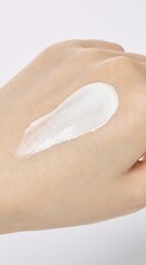 Fototapeta premium a white cream on the back of one's hand