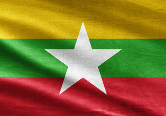 National flag of Myanmar waving with realistic fabric texture, tricolor horizontal stripes and centered white star.