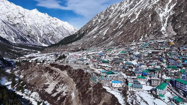 Aerial drone shot offering a stunning aerial perspective of Chitkul, where the snow-covered terrain stretches endlessly, blending seamlessly into the Himalayan horizon.