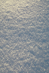 Sparkling Fresh Snow Background with Detailed Frost Crystals in Winter Sunlight