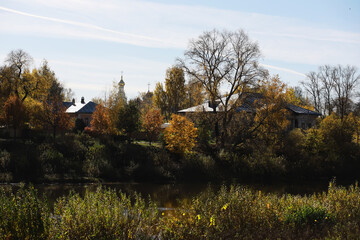 Autumn Landscape with Traditional Village Houses and Trees by the River