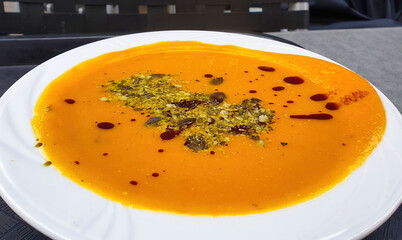 Pumpkin soup in a white bowl