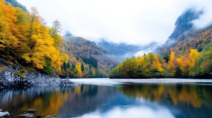 Fototapeta premium A serene lake reflects autumnal trees and misty mountains. Golden and russet foliage lines the calm water. The image is high-resolution, with soft natural lighting. Its peaceful style evokes tranquil