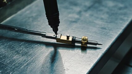 Precision tool being operated on a metal workbench in a workshop environment during daylight hours