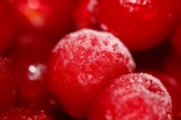 A close up of a red fruit with a frosty coating