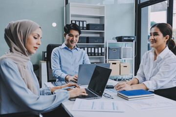 Diverse international executive business partners group discuss report at boardroom meeting table. Multiracial team negotiating project developing business strategy doing paperwork analysis in office.