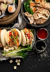 Tasty and hot chinese dumplings with sauces. Asian food concept.