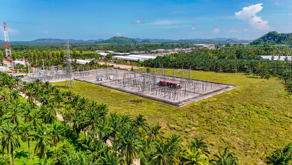 Naklejka premium Aerial view High voltage with beautiful clouds sky. industrial use, electrical power systems. High-voltage power transmission poles for remote areas and technology. Environment and green energy 
