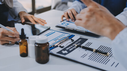 Male and female doctors are having a meeting in a hospital room.