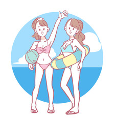 ビーチリゾートにいる水着姿の若い女性2人