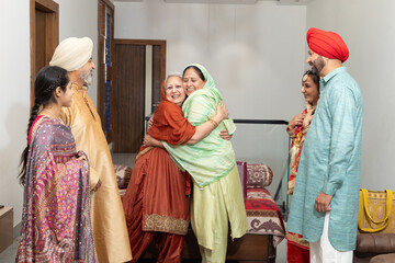 Punjabi sikh family celebrating,meeting and greeting on lohri or baisakhi festival at home, People of punjab, Culture of india. Togetherness and bonding.