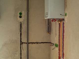  Intricate electrical wiring spilling on wall above hot water heater