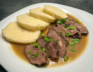 Pork hearts stuffed with bacon with sauce and yeast dumplings