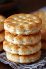 Golden Stack of Freshly Baked Crackers Displaying a Warm Tone and Inviting Texture on a Striped Cloth in a Rustic Setting