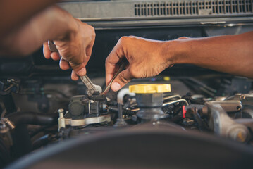 Close up Man hands fixing Car machinery vehicle mechanical service. Mechanic man hands repairing car auto repair shop. open vehicle hood checking up auto mobile. Vehicle Car maintenance engineer.
