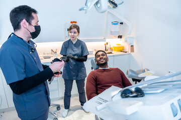 Dentist and assistant preparing for dental check up in modern clinic