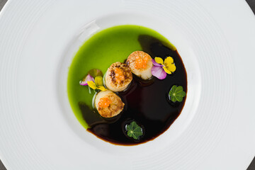 Scallops with two types of sauces and caviar on top