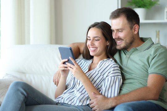 Happy couple reading together an ebook