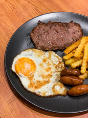 A Homemade Beef Steak looks intact, accompanied by some sauce on the side. It is very delicious and appetizing. Selective focus.