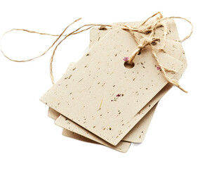 Recycled paper gift tags with embedded wildflower seeds, attached to hemp twine, eco-friendly packaging on white background