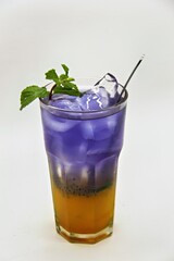 Refreshing Indonesian drink made with passion fruit and butterfly pea flower, Es Markisa Bunga Telang. Naturally vibrant with a sweet and tangy flavor, served cold with ice.