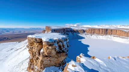 Breathtaking frozen landscape of snow capped mountains and icy cliff formations in a remote rugged wilderness setting  This dramatic serene winter scene showcases the majestic