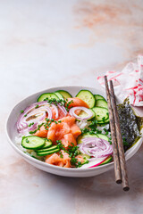 Salmon sushi salad with rice, vegetables and nori.